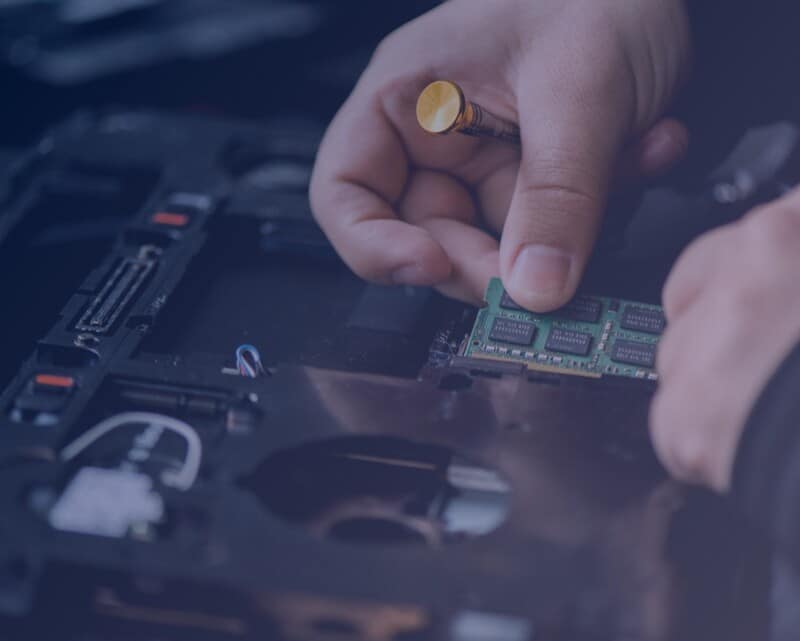 Computer repair specialist changing memory. 